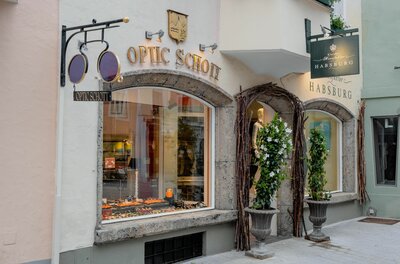Optic Schott Fassade Außenansicht des Optikergeschäfts Optic Schott mit Schaufenster und dekorativem Brillenschild.