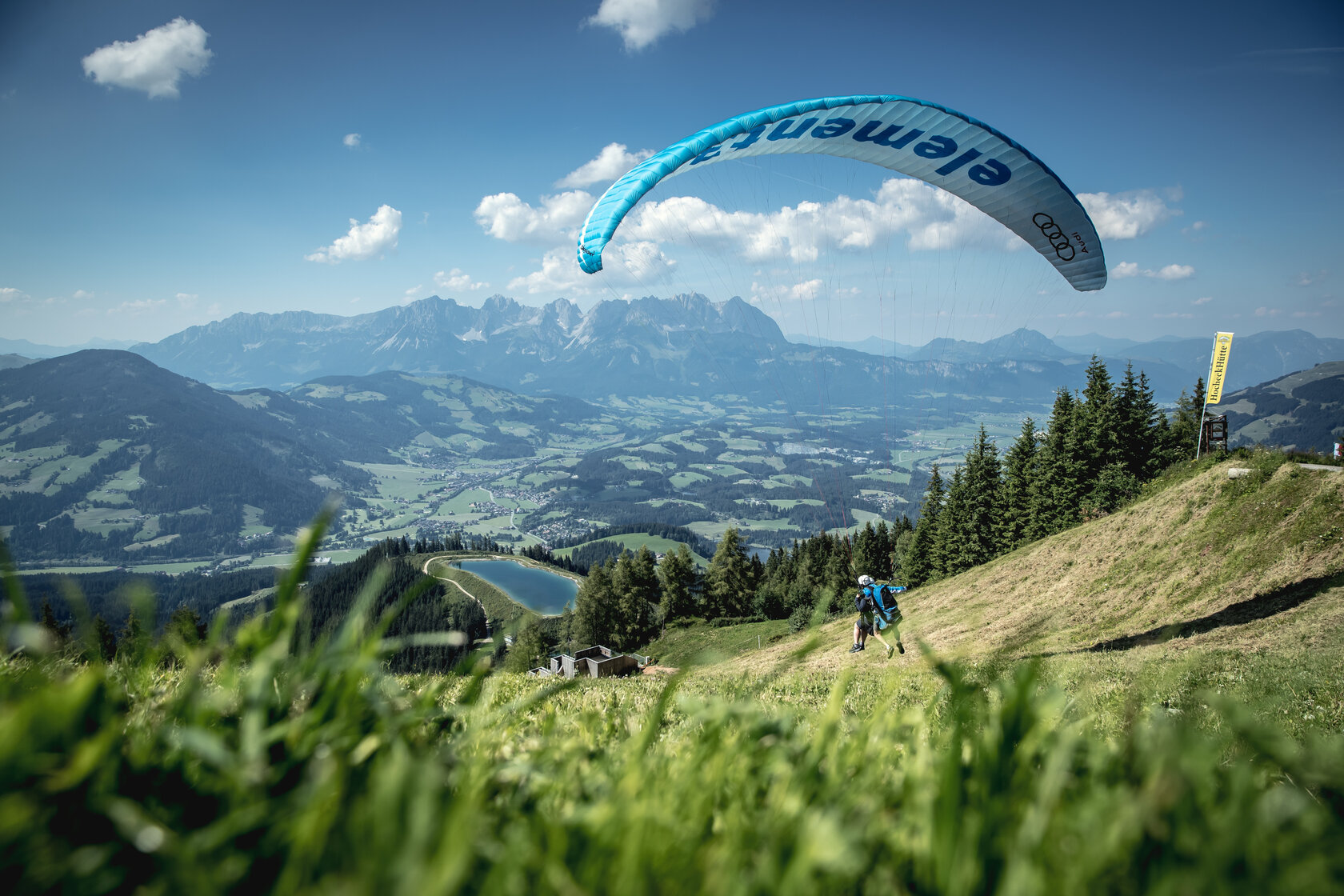 A paraglider taking off from the Hahnenkamm in Kitzbühel