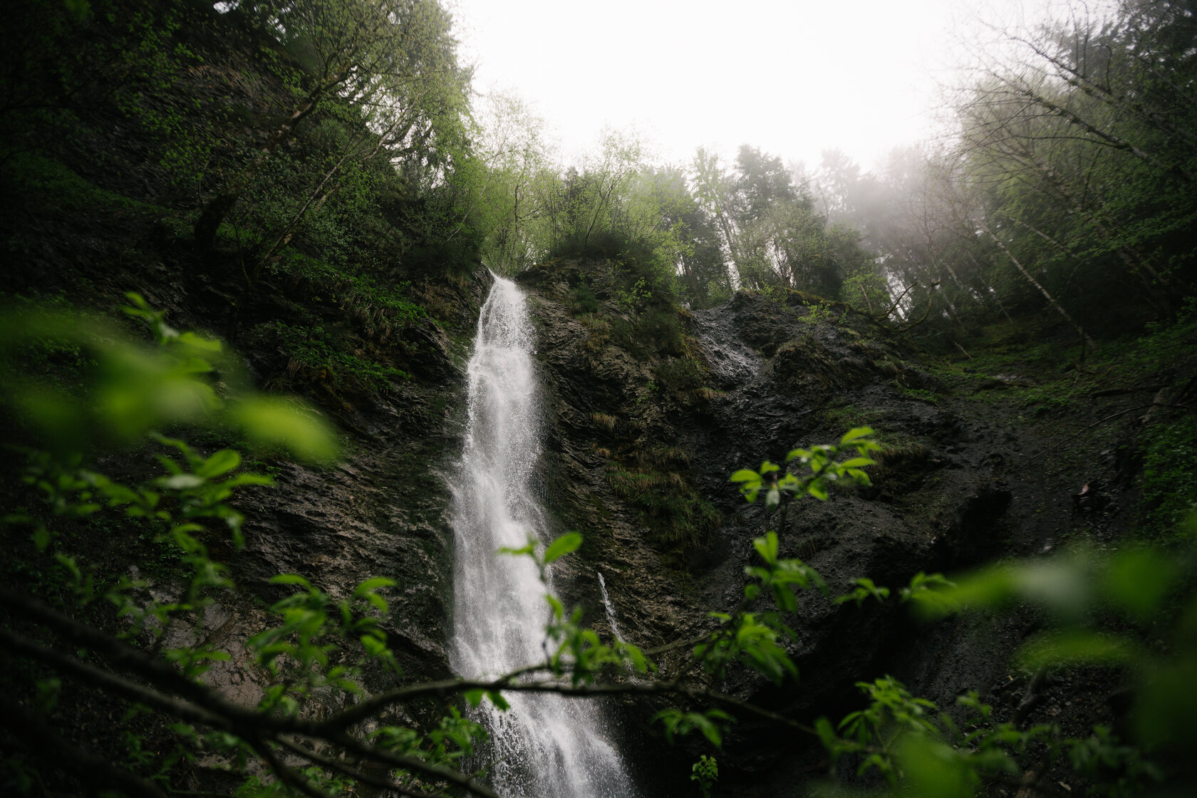 The Schleier Waterfall amidst lush greenery in Kitzbühel