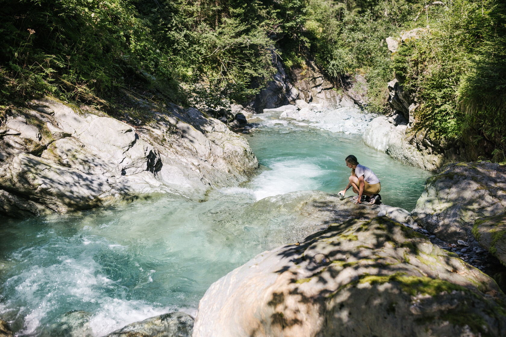Turquoise-green water flows through the rocks